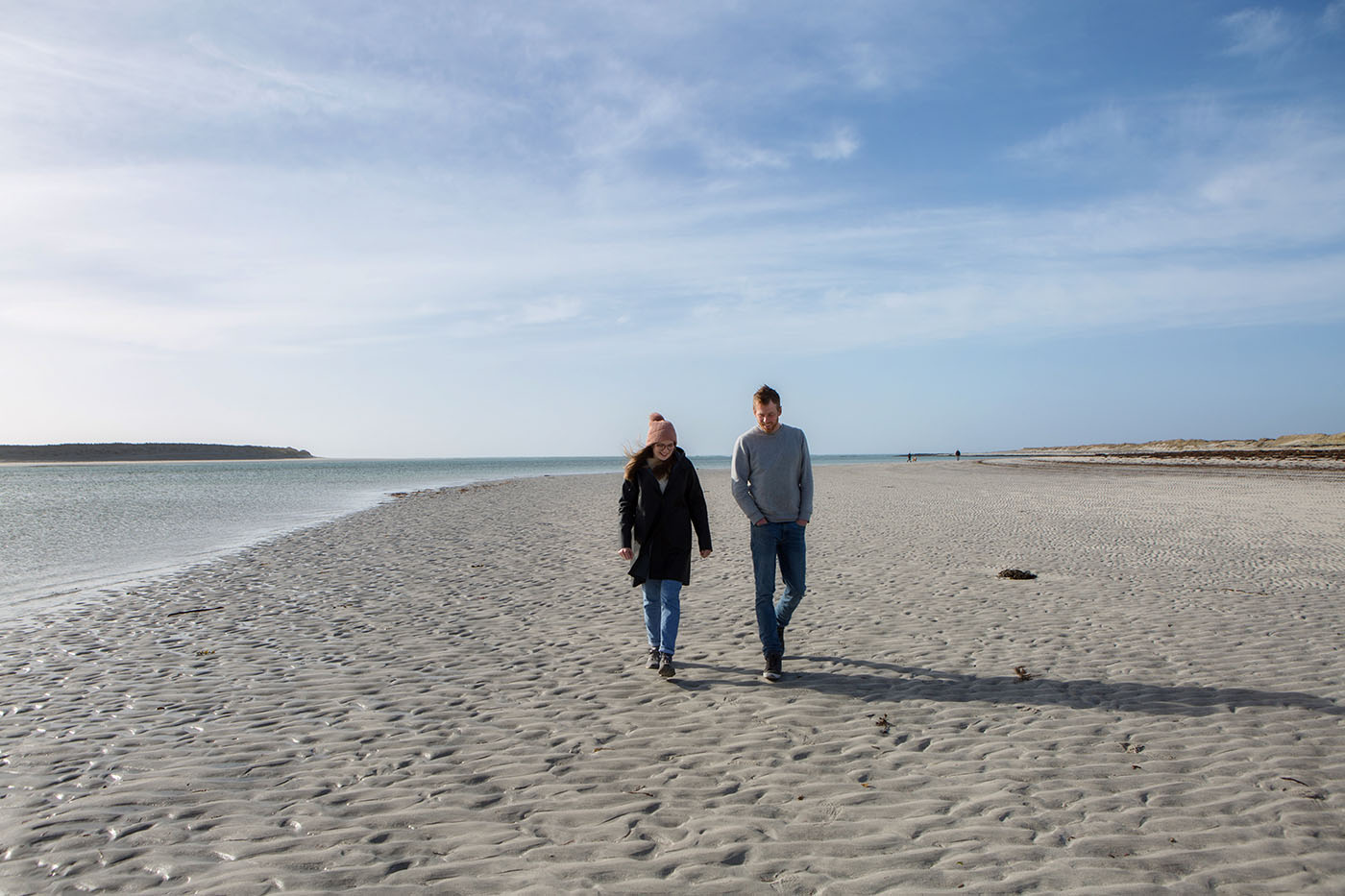 Two people walking on a Uist beach